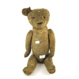 An early 20th Century straw-filled jointed teddy bear.