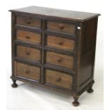 A chest of drawers. Comprising four drawers with wooden handles on ball feet, H93cm x D46cm x W91cm.