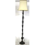 A contemporary floor lamp. Cast metal unscrewable sectional base with white shade, H172cm.