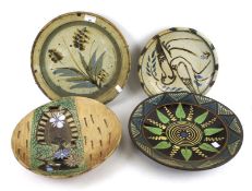 Four assorted Studio Art Pottery charger plates.