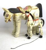 Two Far Eastern carved and painted wooden horses. One made as a puppet with jointed legs. Max.