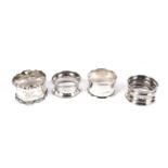 Four assorted silver napkin rings, various makers.