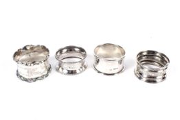 Four assorted silver napkin rings, various makers.