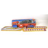 A Japanese clockwork toy tinplate train Tolato Mozdony. Includes train, wagons and track.