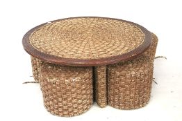 A coffee table and four matching stools. Wooden frame with rope upholstery H49cm x D110cm.