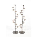 A pair of contemporary floor standing metal and copper tealight holders.