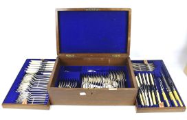 A vintage Walker and Hall oak cased canteen of silver plate cutlery. With two lift out trays, L42.