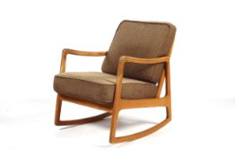 A mid-century Ole Wanscher designed model 120 beech framed open elbow rocking chair with brown