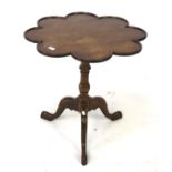 A mahogany tripod occasional table. With a flower shaped top on tapering legs, H67cm D67cm.