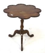 A mahogany tripod occasional table. With a flower shaped top on tapering legs, H67cm D67cm.