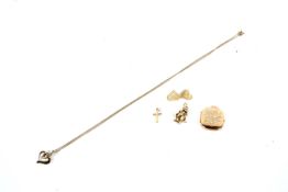 An assortment of 9ct gold jewellery. Including a charm, pendant necklace, earnings and a crucifix.