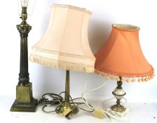 Three assorted brass table lamps.