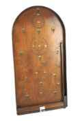 A bagetelle board with balls. Of wooden construction, L76cm x W39cm.
