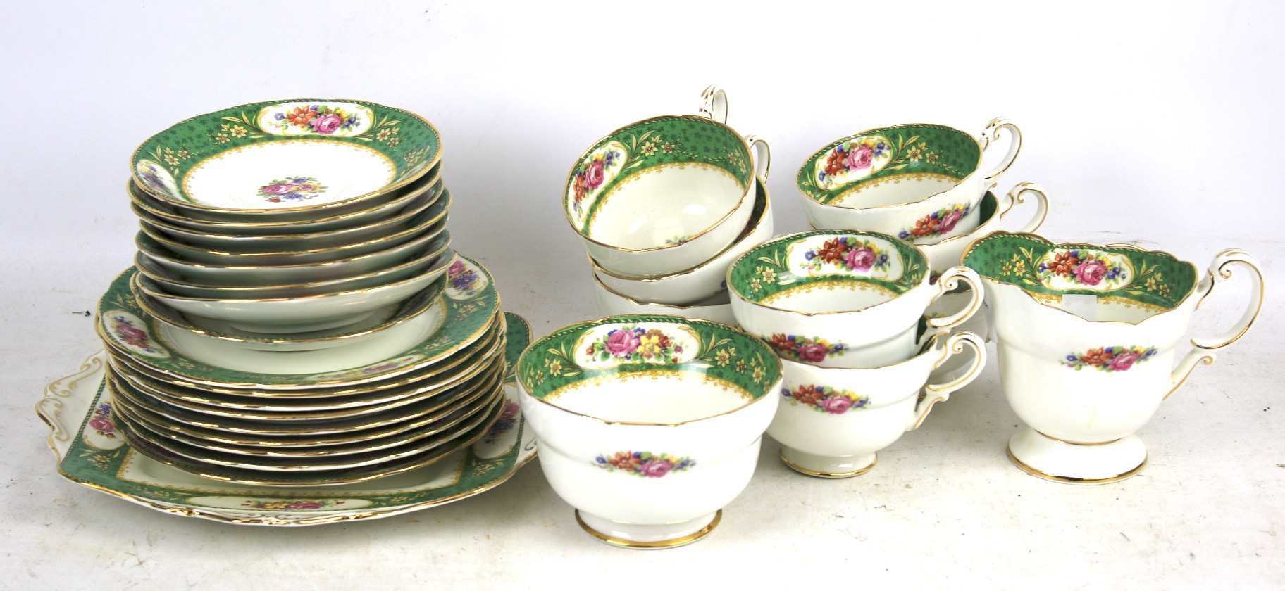 A paragon tea set. White and green with floral detail comprising eight cups, saucers, plates, etc.