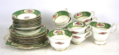A paragon tea set. White and green with floral detail comprising eight cups, saucers, plates, etc.