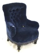A nursing chair. Wooden chair with studded blue upholstery on turned legs, H85cm x D50cm x W70cm.
