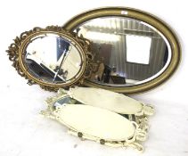 Three oval mirrors. Two finished in gold one folding into three finished in white.