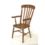 A country farmhouse open elbow chair. A Windsor style ash and elm lathe back chair.