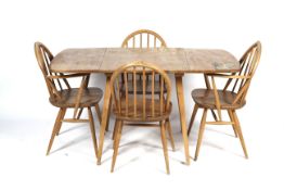 An Ercol light elm and beech drop leaf dining table and four chairs.