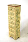 Tall wooden chest with floral decoration, containing seven drawers. H96cm.