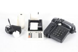 A vintage Seiko Silver-Reed Mini 101 DP printing desk calculator and a BT Tribune push button