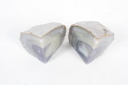 A pair of stone crystal cut and polished bookends. Quarter pieces cut from the same pebble. H13cm.