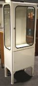 A vintage 1970s white painted glazed metal single medical cabinet.