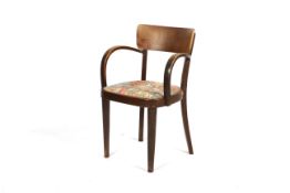 An early to mid 20th century Thonet stained bentwood and ply backed armchair.