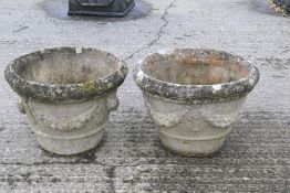 Pair of stone urns decorated with swags H35cm. Condition Report: Diameter 47cm.