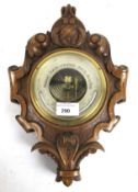 A Victorian oak shield framed android wall barometer. By Burron Malvern.