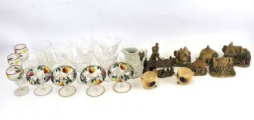 A quantity of cocktail glasses with fruit decoration and eight Lilliput cottages.