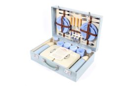 A mid-century Sirram fully fitted picnic hamper in blue and cream colours.