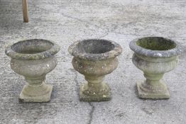 Trio of garden ornaments stone urns. H40cm.