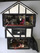 Dolls House. In Tudor style complete with dolls and furniture, H84cm x D43cm x W57cm.