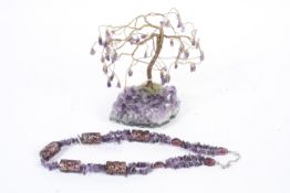 A wirework tree decorated with amethyst beads and an amethyst and glass beaded necklace.