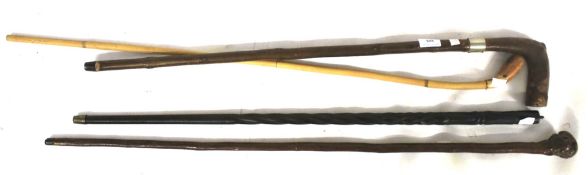 A collection of four walking sticks. Range of sticks mainly hardwood, etc.