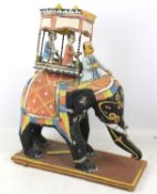 A vintage Indian carved and painted elephant with howdah model.