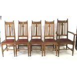 A set of five Arts and Crafts oak chairs. Comprising four dining chairs and a carver.
