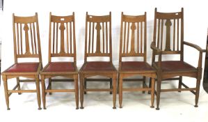 A set of five Arts and Crafts oak chairs. Comprising four dining chairs and a carver.