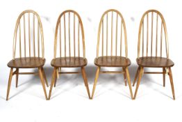 A set of four Ercol light elm and beech hoop back dining chairs, On splayed tapering legs,