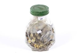 A comprehensive collection of military buttons in a jar.