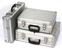 Three aluminum camera cases.