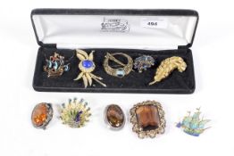 Nine assorted brooches including vintage. Two modeled as ships, faux amber, etc.