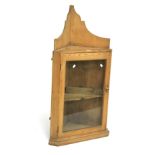 A Victorian pine corner cupboard. With a glazed door opening to reveal a single shelf, L59cm x D40.