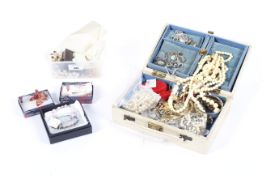 An assortment of costume jewellery in a jewellery box and a similar bag.