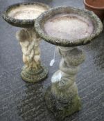 Two ornamental garden stone bird baths. Both with cherubs on the pedestal.