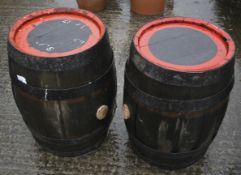Two wooden barrels with metal bindings.