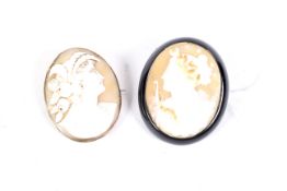 Two large cameo brooches. One set in a gilt frame and the other in a black plastic plaque, L5.