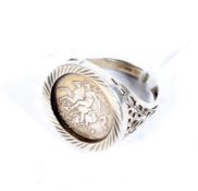 A gentleman's silver and 'St George' imitation coin signet ring. Size X, 8.