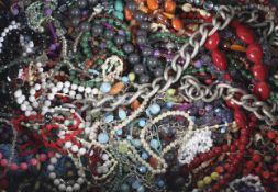 A collection of miscellaneous costume jewellery. Including beads, necklaces, brooches, etc.
